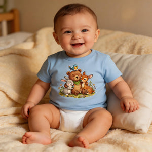 Smiling baby in a blue animal graphic t-shirt and diaper on a cozy blanket