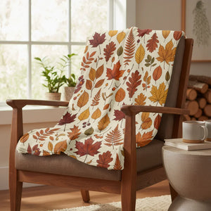 Cozy fall leaves throw blanket draped on armchair in sunlit living room