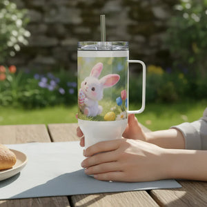 Hand holding a tumbler with cute bunny and Easter egg design, spring garden background
