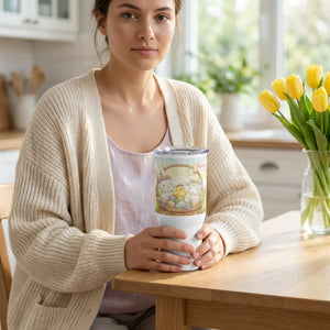 Woman holding an Easter-themed tumbler with bunny and chick design in a cozy kitchen.
