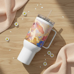 White insulated tumbler with a pastel bunny, chick, and flowers illustration on wooden table.