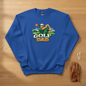 Blue Golf Dad sweatshirt with golfer graphic, laid on wood, golf glove and tees beside it