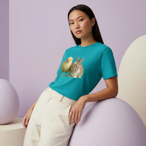 Woman wearing teal t-shirt with chick and bunny graphic, modern pastel background