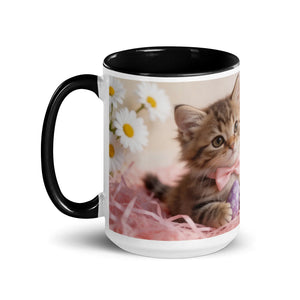 White ceramic mug with black handle and interior, featuring a kitten with a pink bow and daisies design