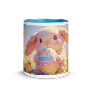 White ceramic mug with blue interior featuring a cute bunny holding a decorated Easter egg