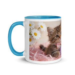White ceramic mug with blue handle and interior, featuring a cute kitten, daisies, and pink decor
