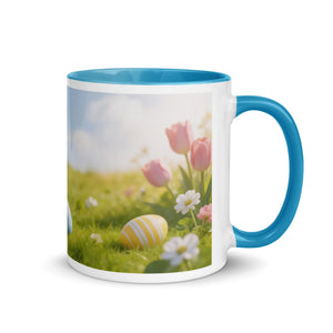White ceramic mug with blue handle and interior, floral and Easter egg design
