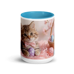 White ceramic mug with blue interior featuring a kitten in a pink bow and Easter eggs design.