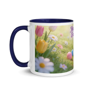 White ceramic mug with dark blue handle and rim, featuring spring flowers and Easter eggs design.