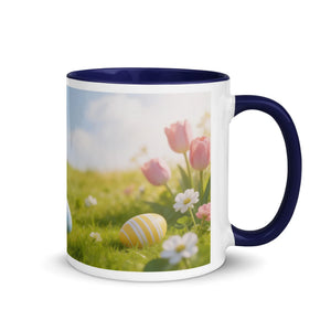 White ceramic mug with dark blue handle and rim, featuring spring flowers and Easter eggs