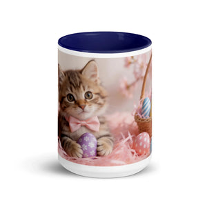 White ceramic mug with dark blue interior featuring a kitten and Easter egg design