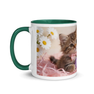 White ceramic mug with dark green handle and interior, featuring a kitten, daisies, and pink straw design