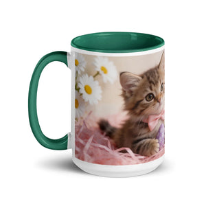 White ceramic mug with dark green interior and handle, featuring a cute kitten, daisies, and pink accents
