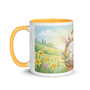 White ceramic mug with golden yellow handle and interior, featuring a cute bunny and spring flowers illustration.