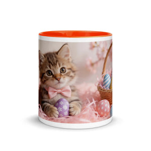 White ceramic mug with orange interior featuring a kitten and decorative Easter eggs design