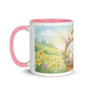 White ceramic mug with pink handle and interior, featuring a cute bunny in a spring floral field illustration.
