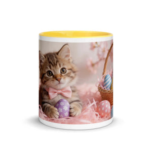 White ceramic mug with yellow interior featuring a kitten, Easter eggs, and a basket.