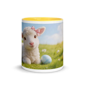 White ceramic mug with yellow interior, featuring a cute lamb with pink bow and Easter egg design on grassy field