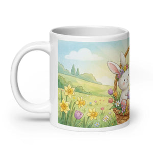 White ceramic mug with illustration of a bunny in a basket among spring flowers in a meadow