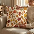 Cozy living room with a woman holding an autumn leaves throw pillow on a beige sofa.