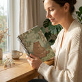 Woman holding spiral notebook with illustrated bears and 'Happy Mother's Day' cover design
