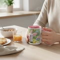 Person holding cute bunny mug with pink handle at breakfast table with toast, cereal, and juice.
