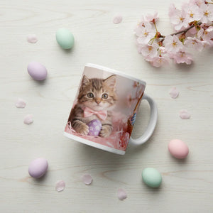 Ceramic mug with a cute kitten in a pink bow and Easter egg, surrounded by pastel eggs and cherry blossoms.