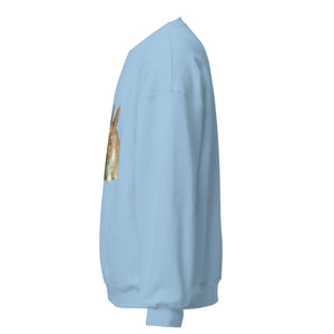 Light blue unisex crew neck sweatshirt with a brown rabbit graphic on the front, side view