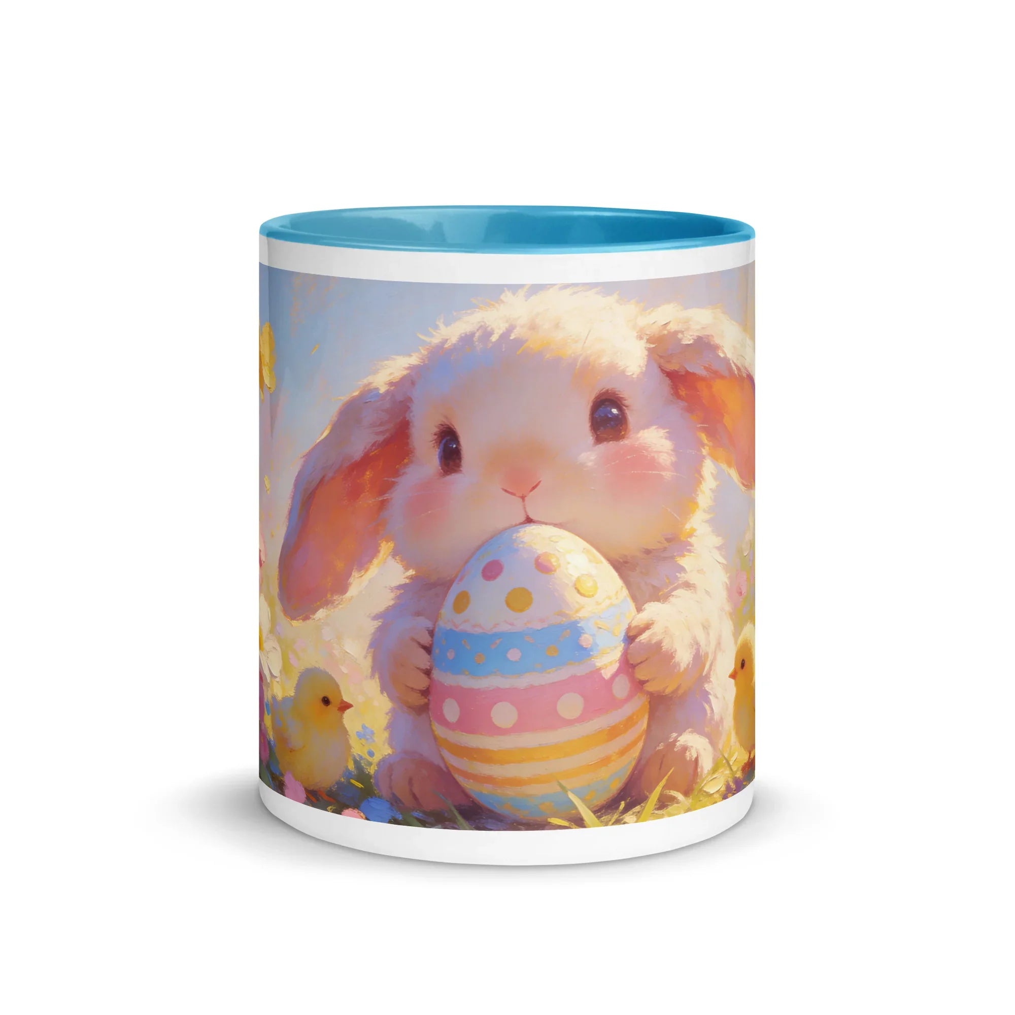 White ceramic mug with blue interior featuring a cute bunny holding a decorated Easter egg