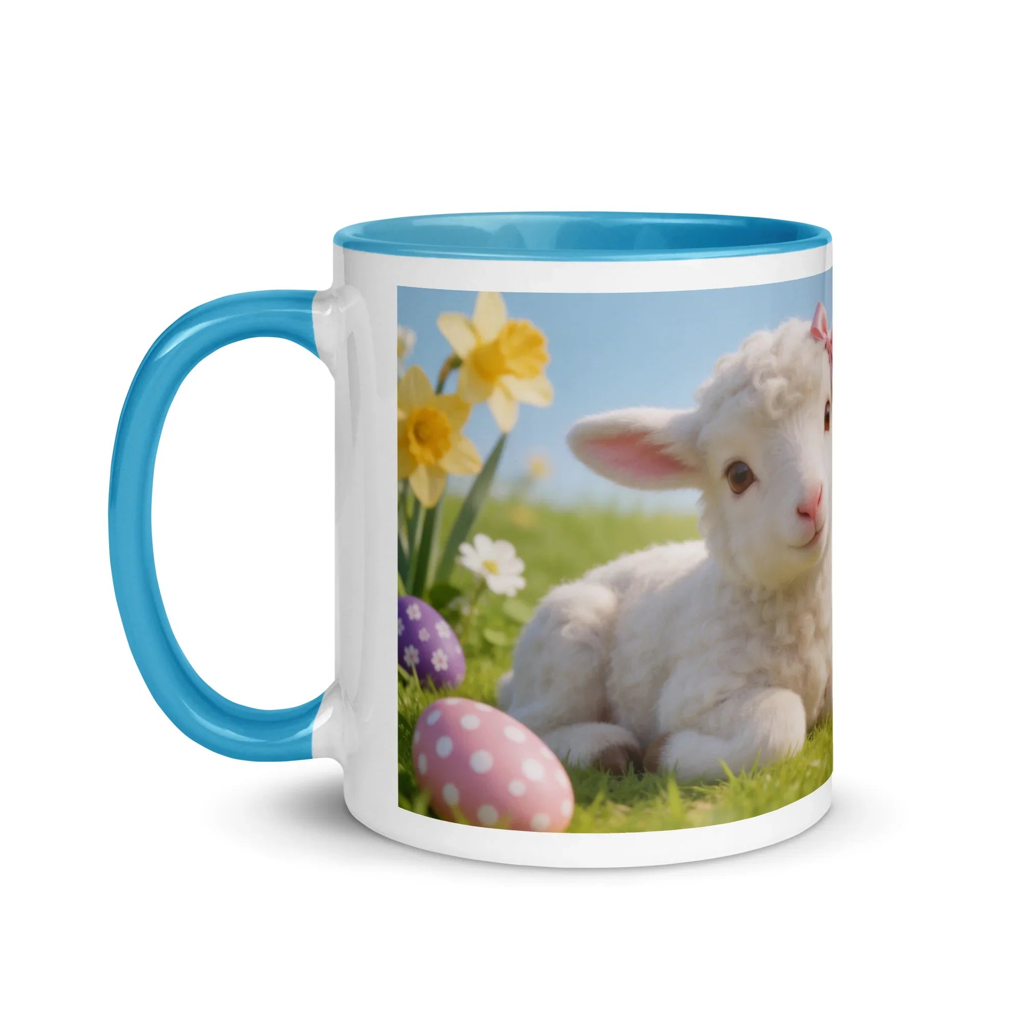 White ceramic mug with blue handle and rim, featuring a lamb, daffodils, and decorated Easter eggs