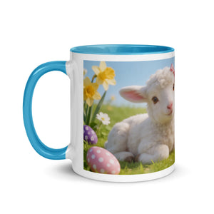 White ceramic mug with blue handle and rim, featuring a lamb, daffodils, and decorated Easter eggs