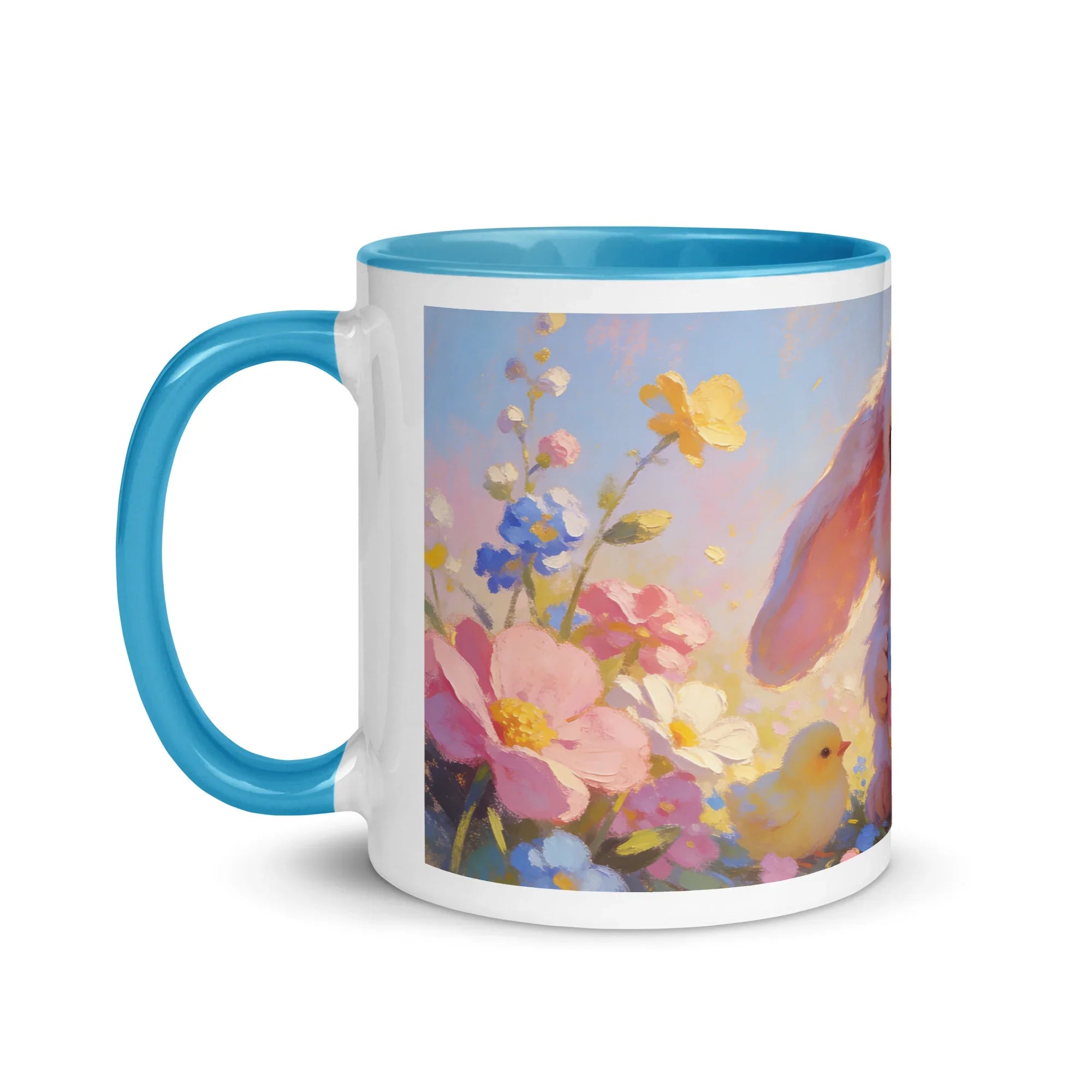 White ceramic mug with blue handle, featuring pastel floral and bunny illustration