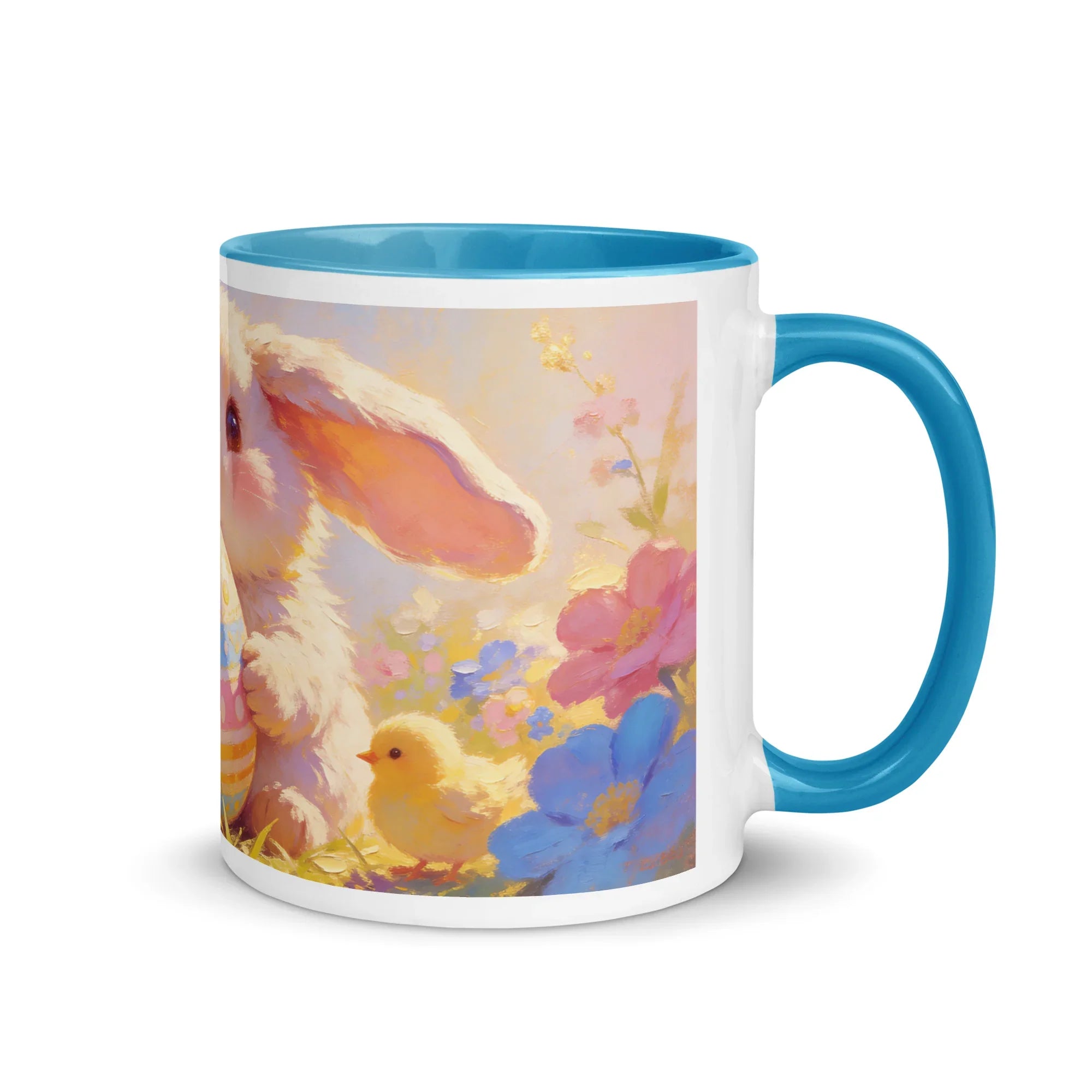 White ceramic mug with blue interior and handle, featuring a bunny, chick, and colorful flowers.