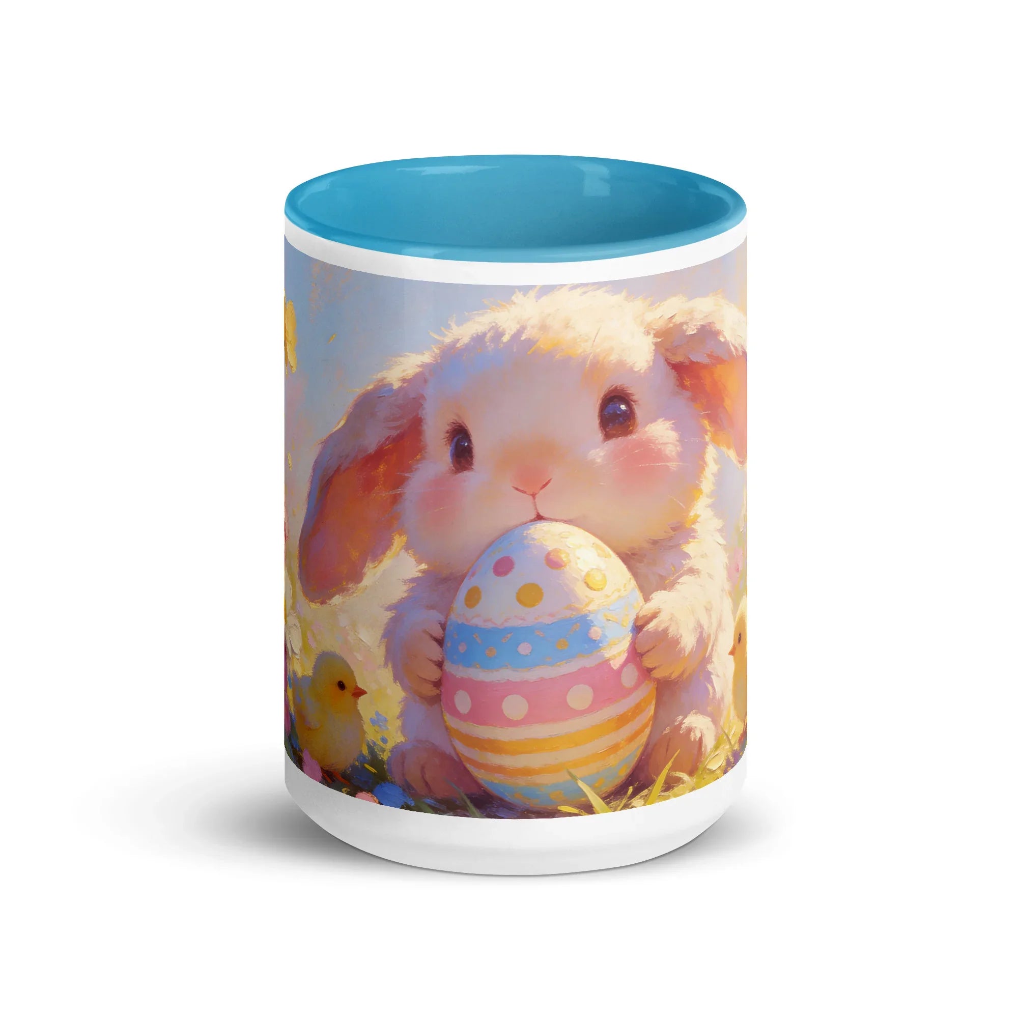 White ceramic mug with blue interior featuring a cute bunny holding a decorated Easter egg