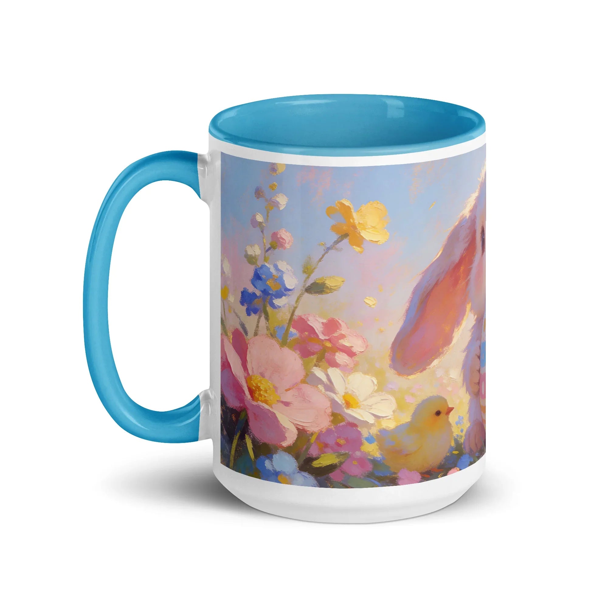 White ceramic mug with blue interior, featuring a pastel floral design, bunny ear, and chick