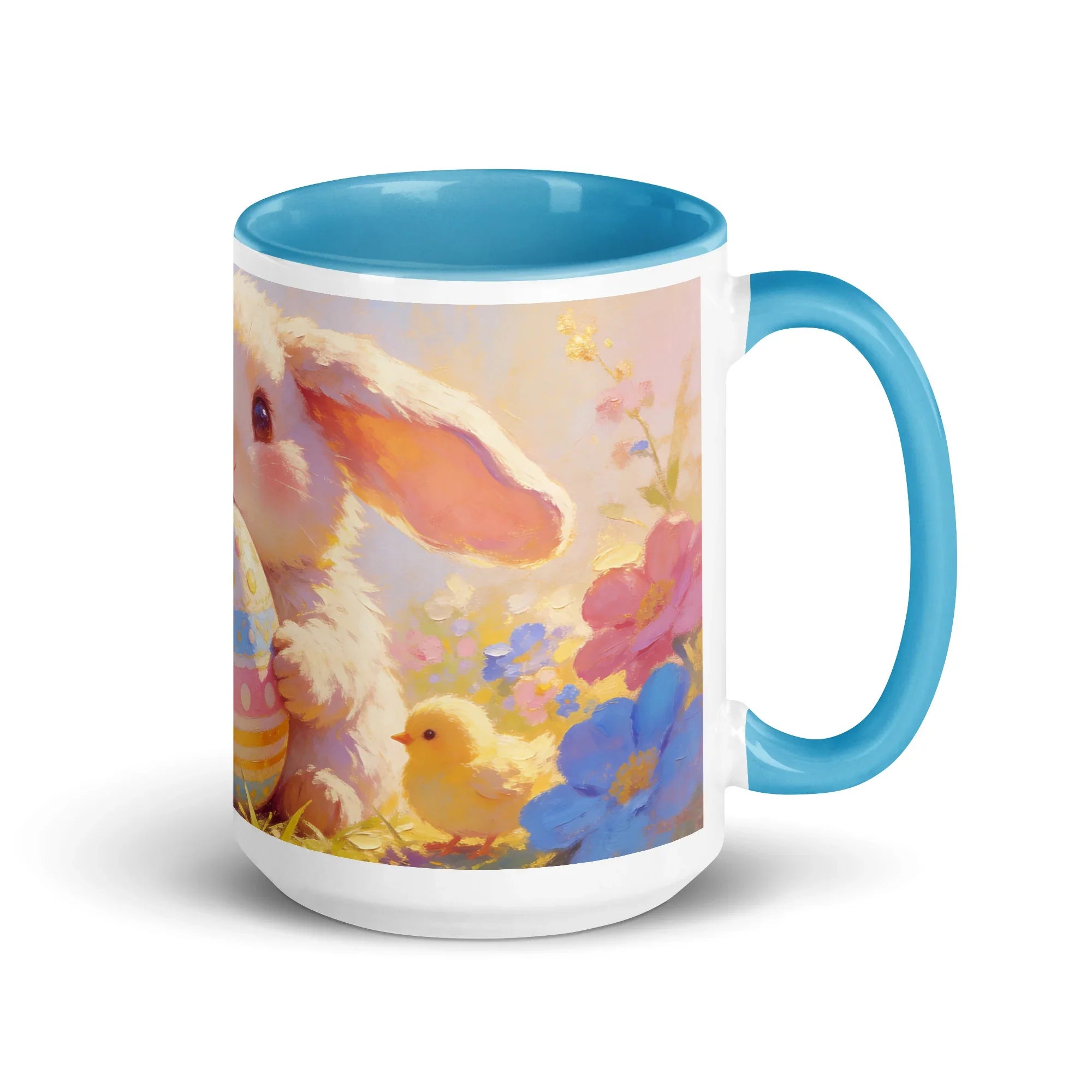 White ceramic mug with blue interior, featuring a bunny, chick, and colorful spring flowers.