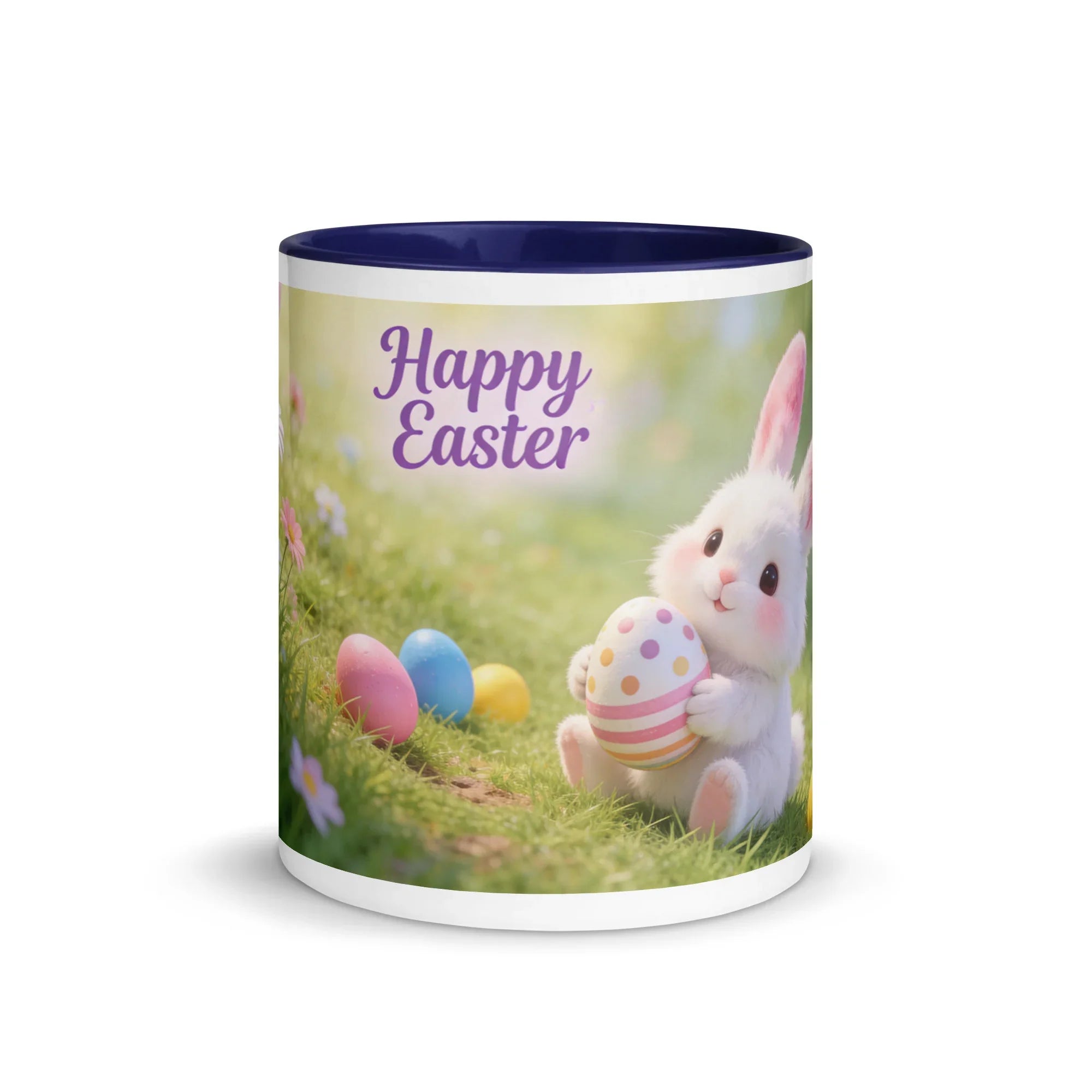 White ceramic mug with dark blue interior, featuring a cute bunny holding a decorated Easter egg, colorful eggs, and 'Happy Easter' text on grass.