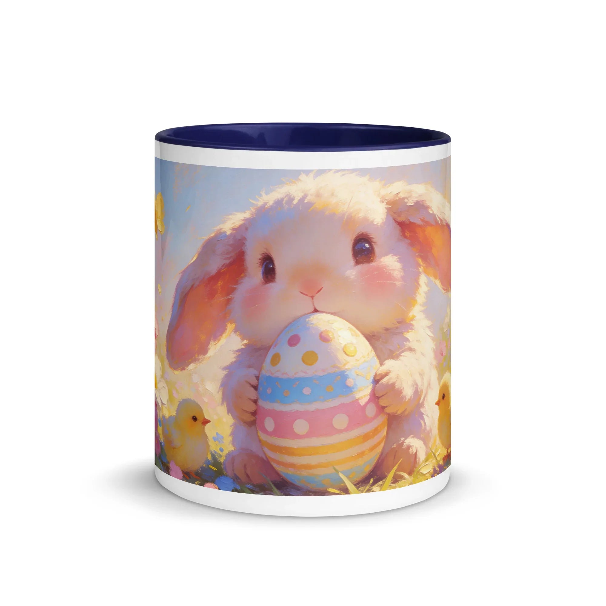 White ceramic mug with dark blue interior, featuring a cute bunny holding a pastel Easter egg.