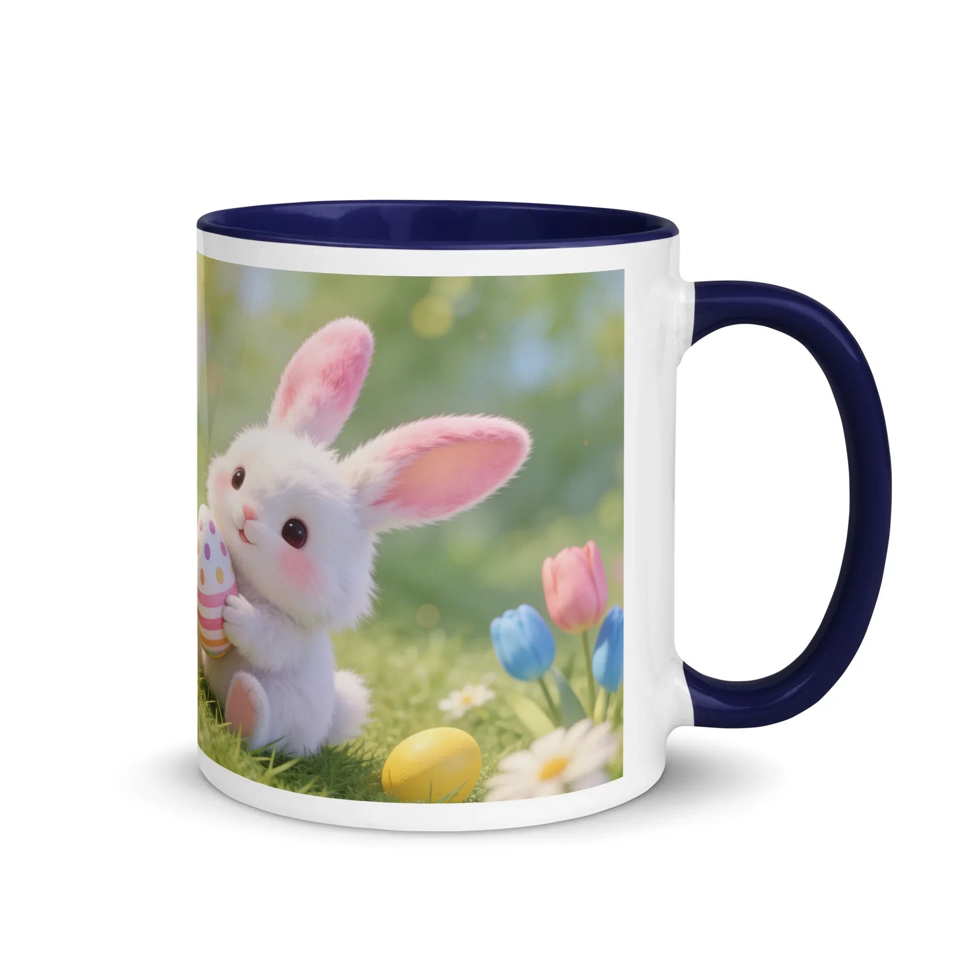 White ceramic mug with dark blue handle and rim, featuring a cute bunny with Easter eggs and spring flowers.