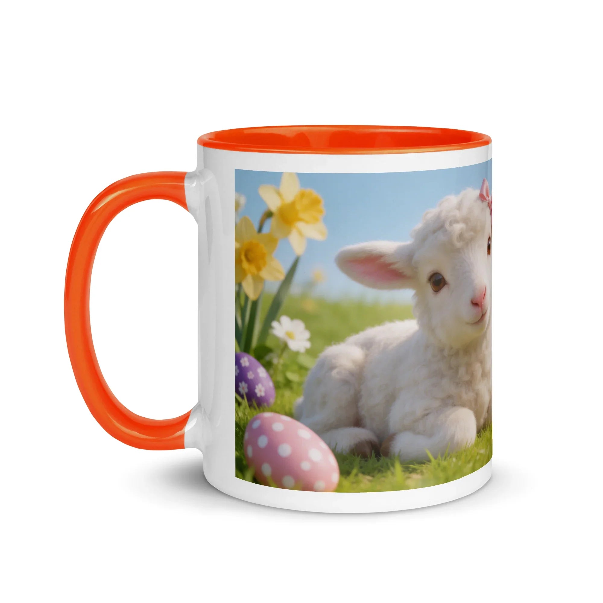 White ceramic mug with orange handle and rim, featuring a cute lamb and Easter egg design