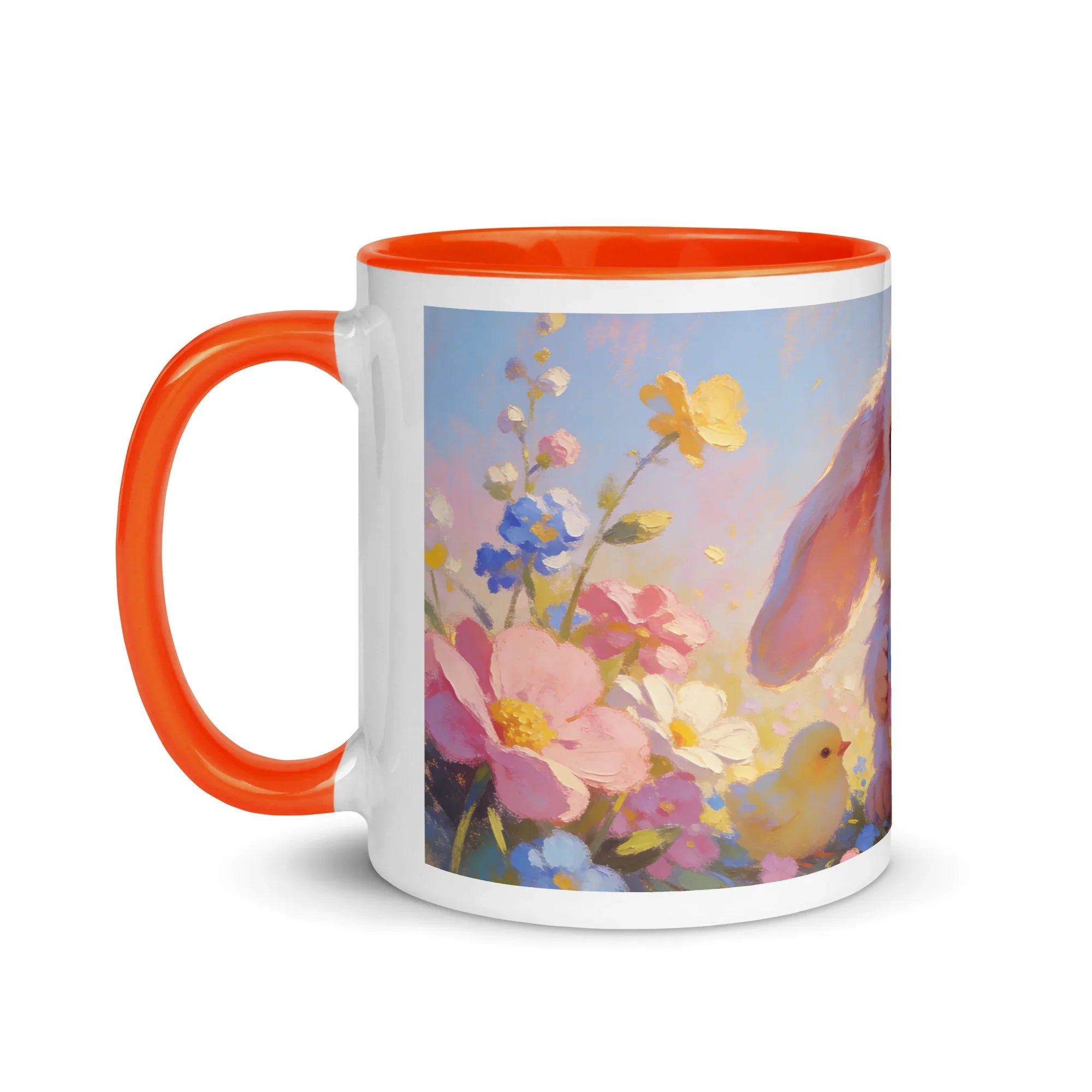 White ceramic mug with orange handle, featuring a floral and bunny design with spring flowers.