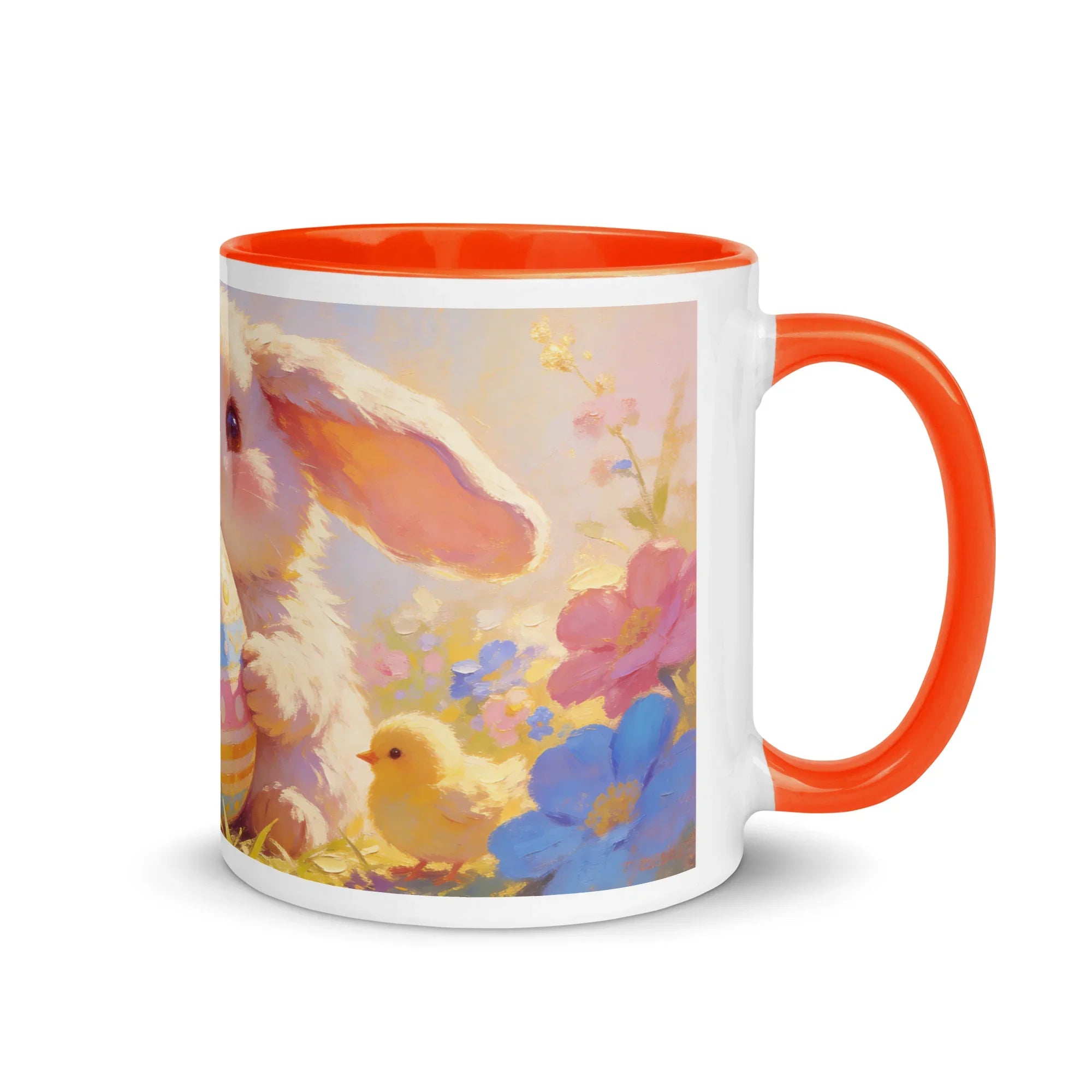White ceramic mug with orange handle and rim, featuring a cute bunny, chick, and colorful flowers.