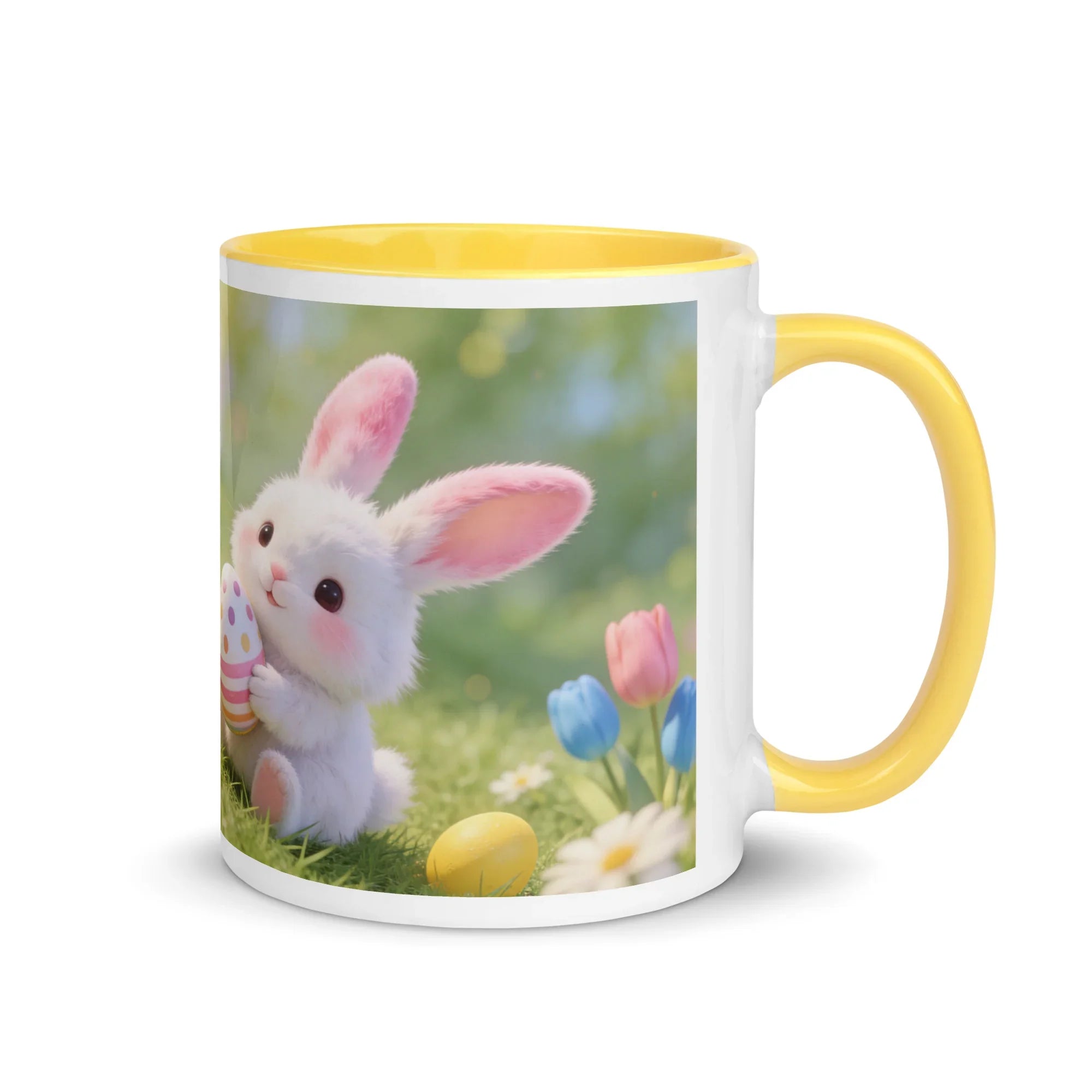 White ceramic mug with yellow handle, featuring a cute bunny holding a decorated egg and spring flowers.