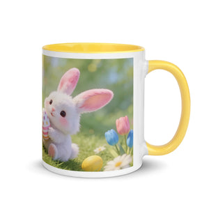 White ceramic mug with yellow handle, featuring a cute bunny holding a decorated egg and spring flowers.