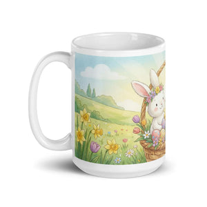 White ceramic mug with handle on left, featuring cute bunny in spring flower field and Easter eggs illustration.