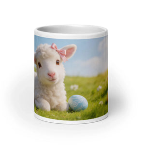 White glossy mug featuring a cute lamb with a pink bow and Easter egg on green grass