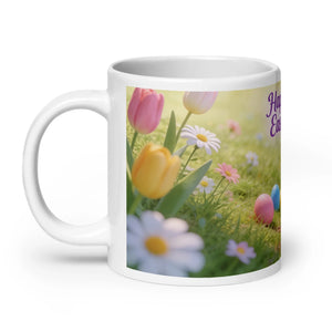White glossy ceramic mug with colorful Easter tulips, daisies, and eggs on grassy background